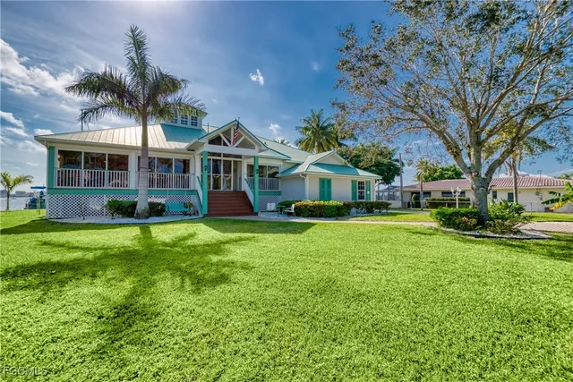 a front view of a house with a garden and yard