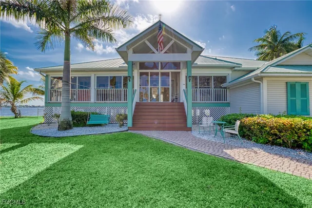 a front view of a house with garden and porch