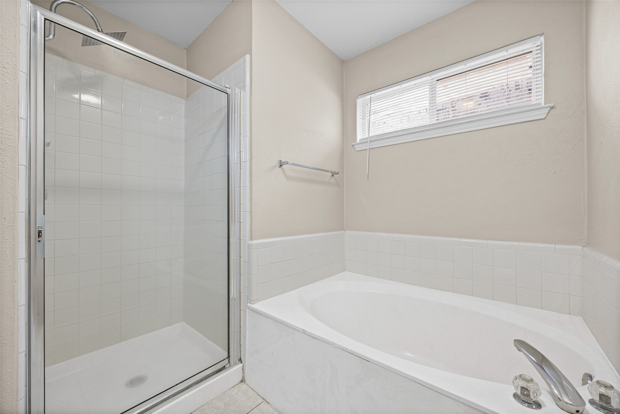 2432 Roundabout Lane Round Rock, TX 78664 - Photo 15 of 22 A well-appointed bathroom features a glass-enclosed shower and a deep soaking tub.