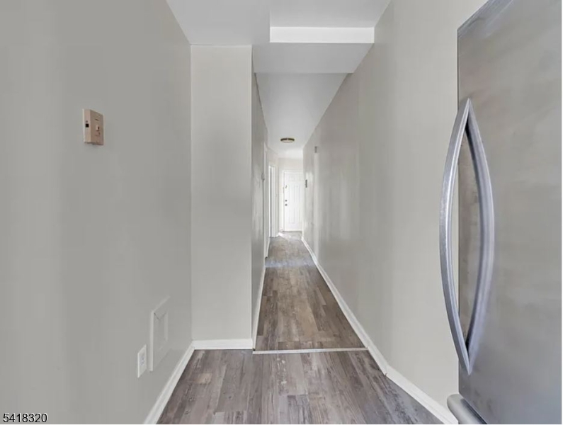 84 Second Street, Unit 4 Elizabeth Port, NJ 07206 - Photo 11 of 16 a view of a hallway with wooden floor and staircase