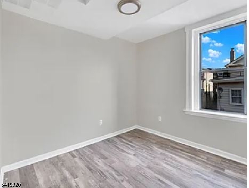 84 Second Street, Unit 4 Elizabeth Port, NJ 07206 - Photo 3 of 16 a view of empty room with wooden floor