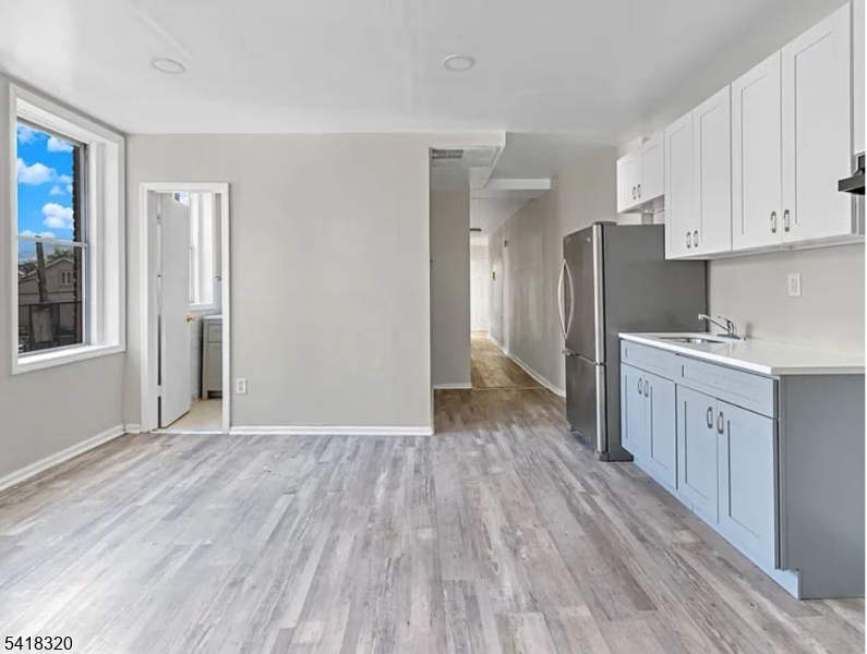 84 Second Street, Unit 4 Elizabeth Port, NJ 07206 - Photo 7 of 16 a view of a kitchen with wooden floor and electronic appliances
