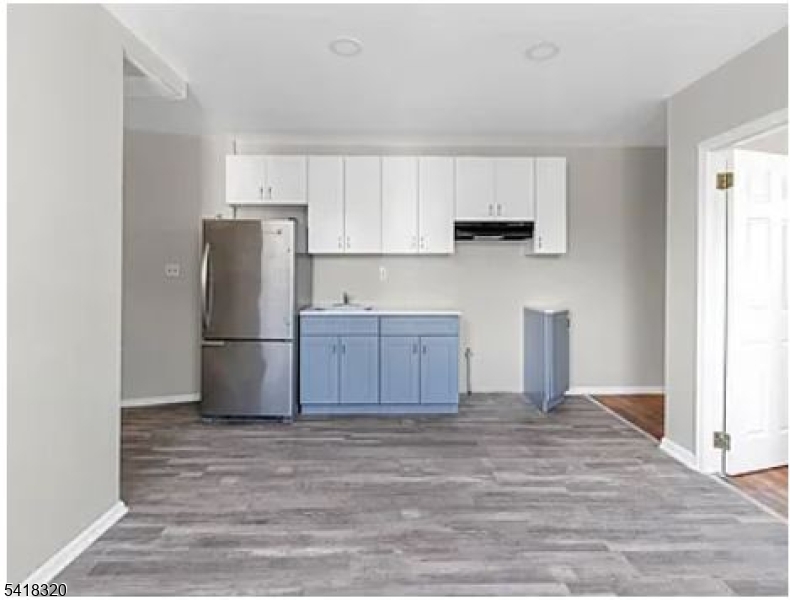 84 Second Street, Unit 4 Elizabeth Port, NJ 07206 - Photo 8 of 16 a kitchen with a refrigerator sink and cabinets