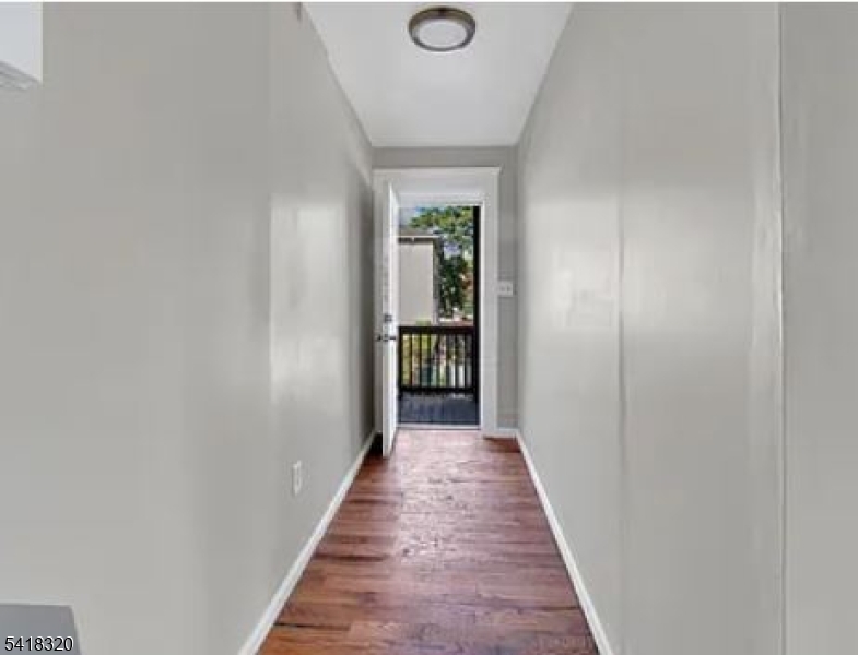 84 Second Street, Unit 4 Elizabeth Port, NJ 07206 - Photo 10 of 16 a view of a hallway with wooden floor