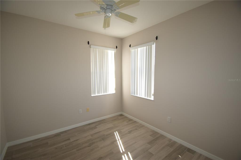534 Grasslands Village Circle, Unit 534 Lakeland, FL 33803 - Photo 12 of 35 an empty room with wooden floor and windows