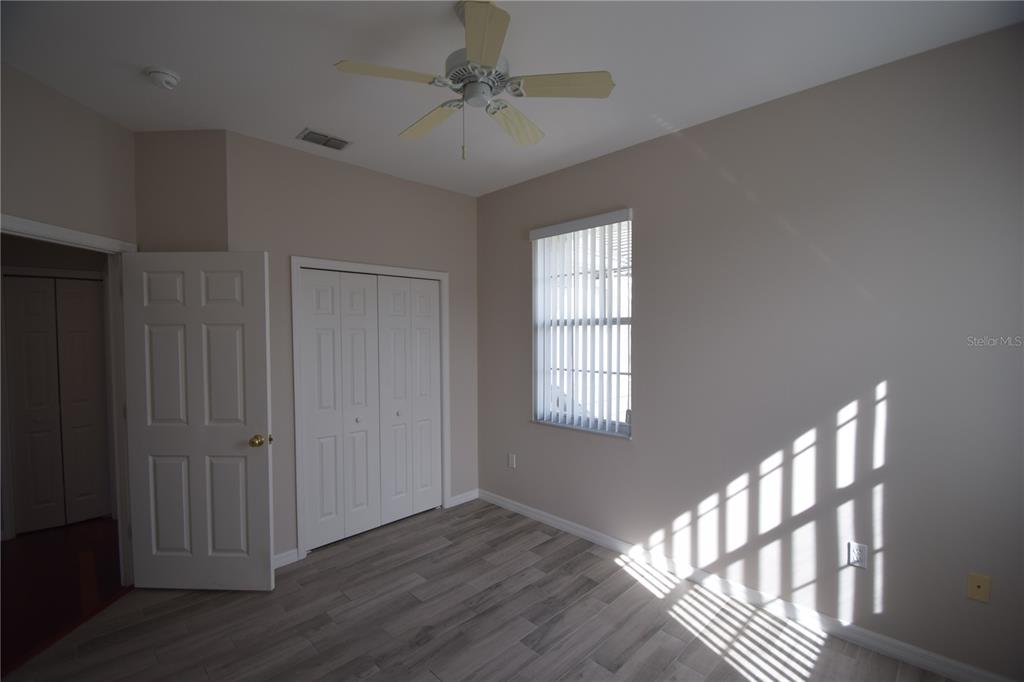 534 Grasslands Village Circle, Unit 534 Lakeland, FL 33803 - Photo 13 of 35 a view of an empty room with wooden floor and a window