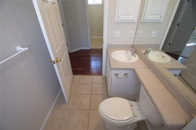 a bathroom with a toilet a sink and a mirror