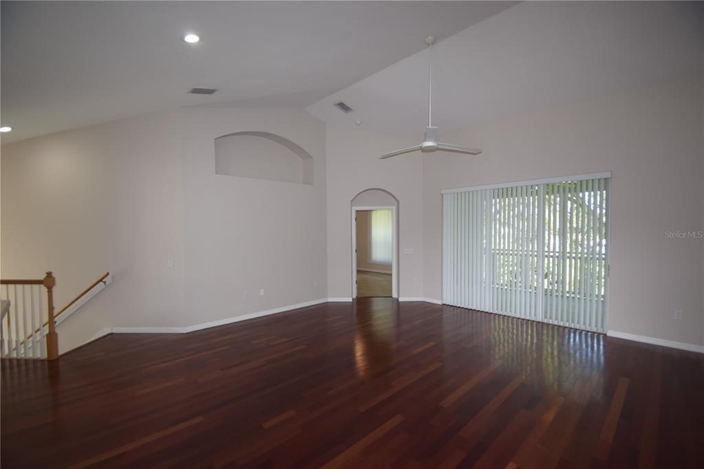 534 Grasslands Village Circle, Unit 534 Lakeland, FL 33803 - Photo 21 of 35 a view of an empty room with wooden floor and a window