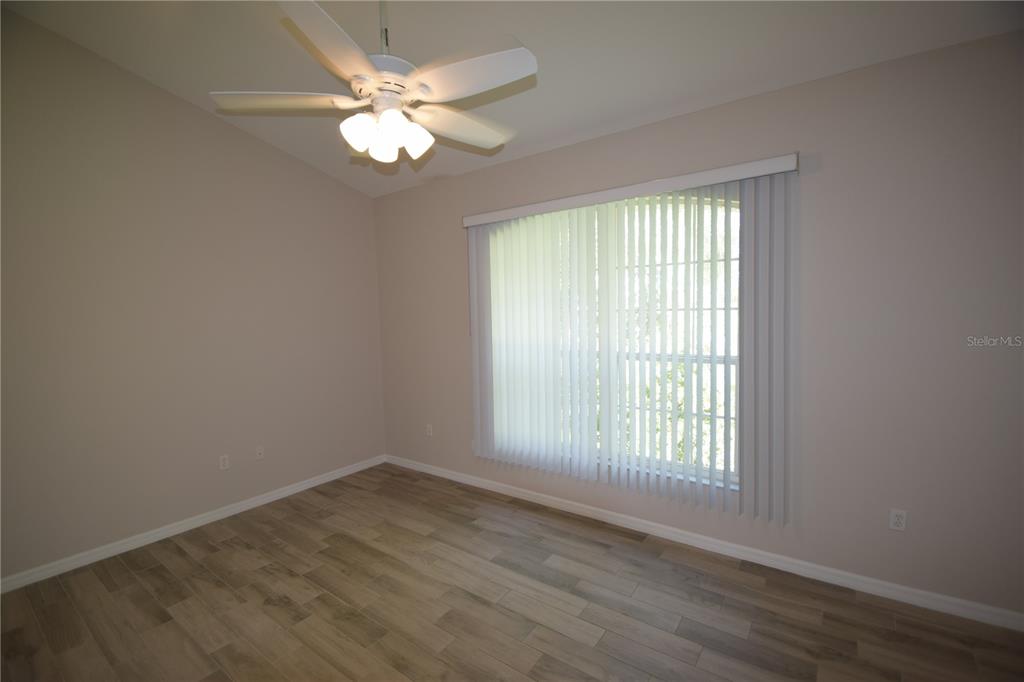 534 Grasslands Village Circle, Unit 534 Lakeland, FL 33803 - Photo 23 of 35 wooden floor in an empty room with a window