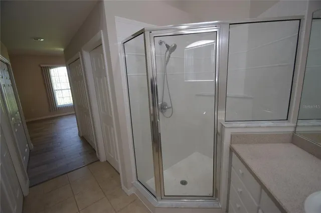 a bathroom with a glass door shower