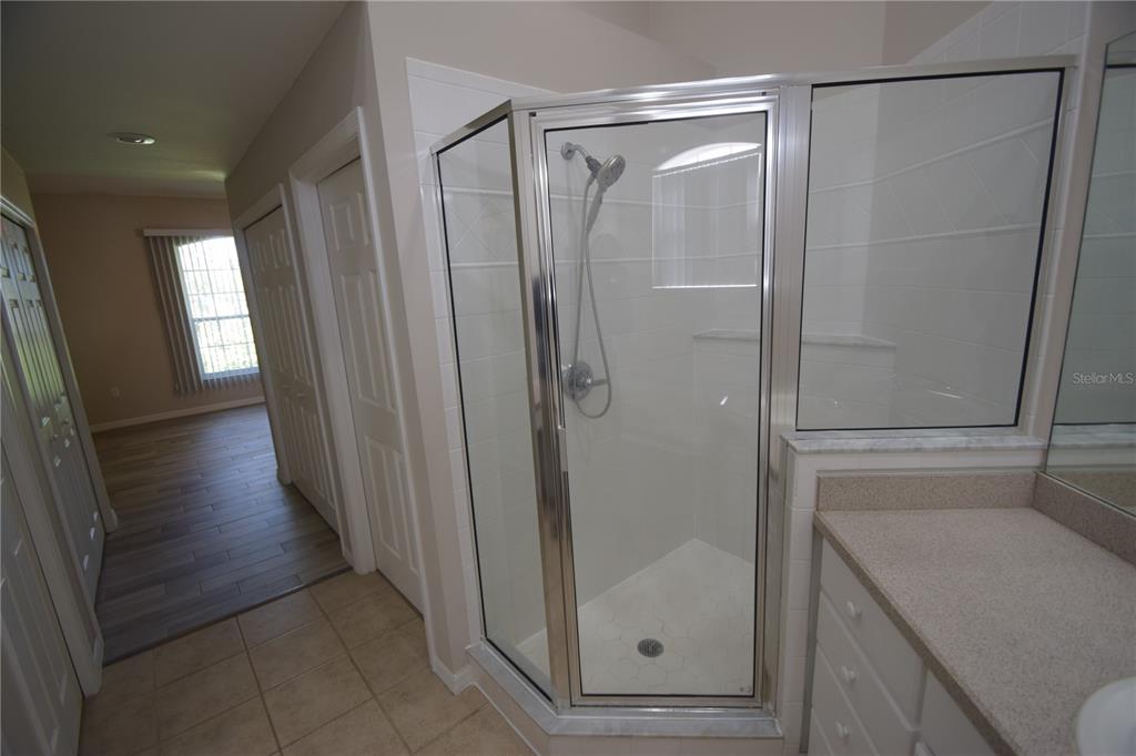 534 Grasslands Village Circle, Unit 534 Lakeland, FL 33803 - Photo 28 of 35 a bathroom with a glass door shower