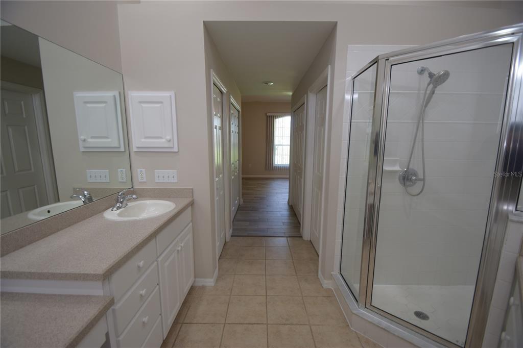 534 Grasslands Village Circle, Unit 534 Lakeland, FL 33803 - Photo 29 of 35 a bathroom with a shower sink and mirror