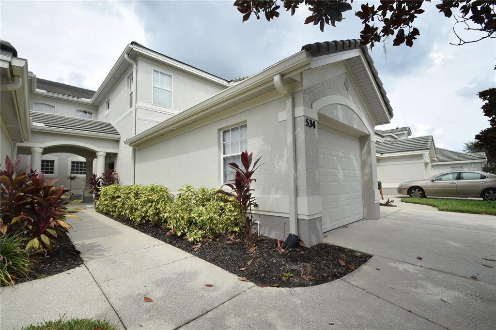 534 Grasslands Village Circle, Unit 534 Lakeland, FL 33803 - Photo 3 of 35 a front view of a house with garden