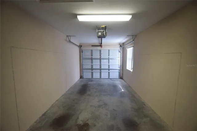 en empty room with windows and ceiling fan