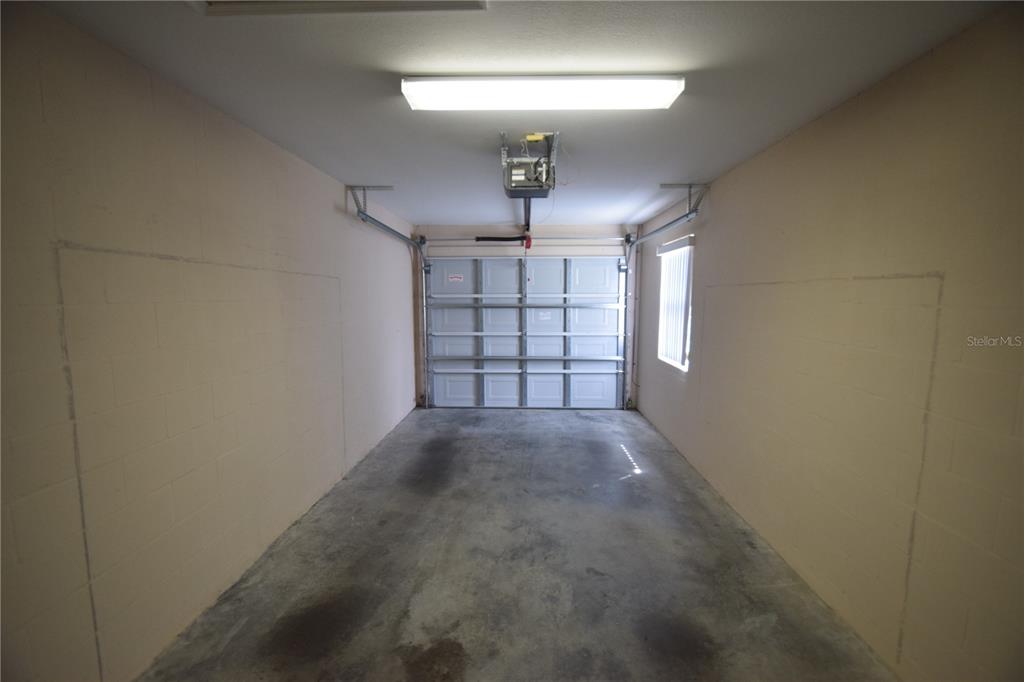 534 Grasslands Village Circle, Unit 534 Lakeland, FL 33803 - Photo 35 of 35 en empty room with windows and ceiling fan