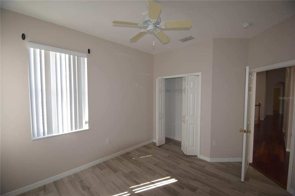 534 Grasslands Village Circle, Unit 534 Lakeland, FL 33803 - Photo 10 of 35 a view of an empty room with wooden floor and a window