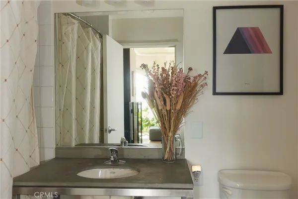 a view of a bathroom with a sink and a mirror