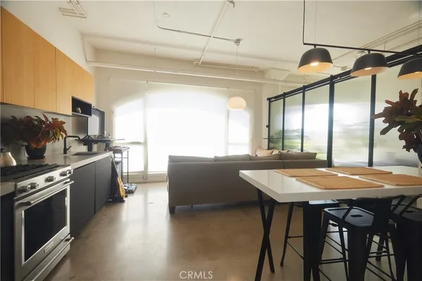 a kitchen with a table chairs sink and stove