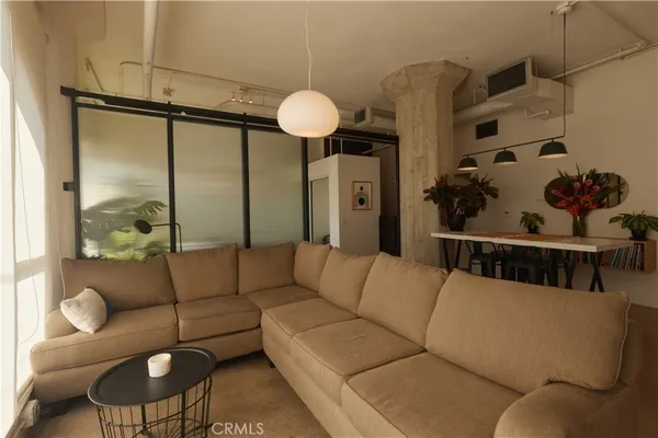 a living room with furniture and a large window