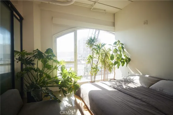 a bed sitting in a bedroom next to a window