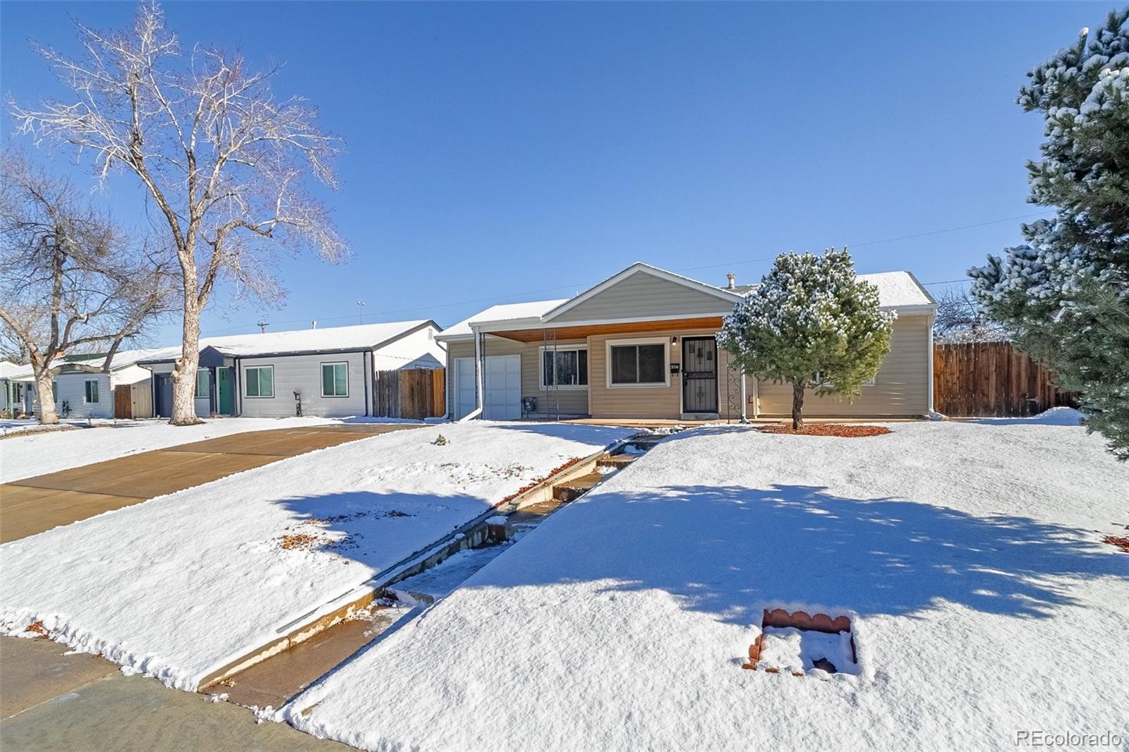 3016 South Grape Way Denver, CO 80222 - Photo 1 of 27 a front view of a house with a yard