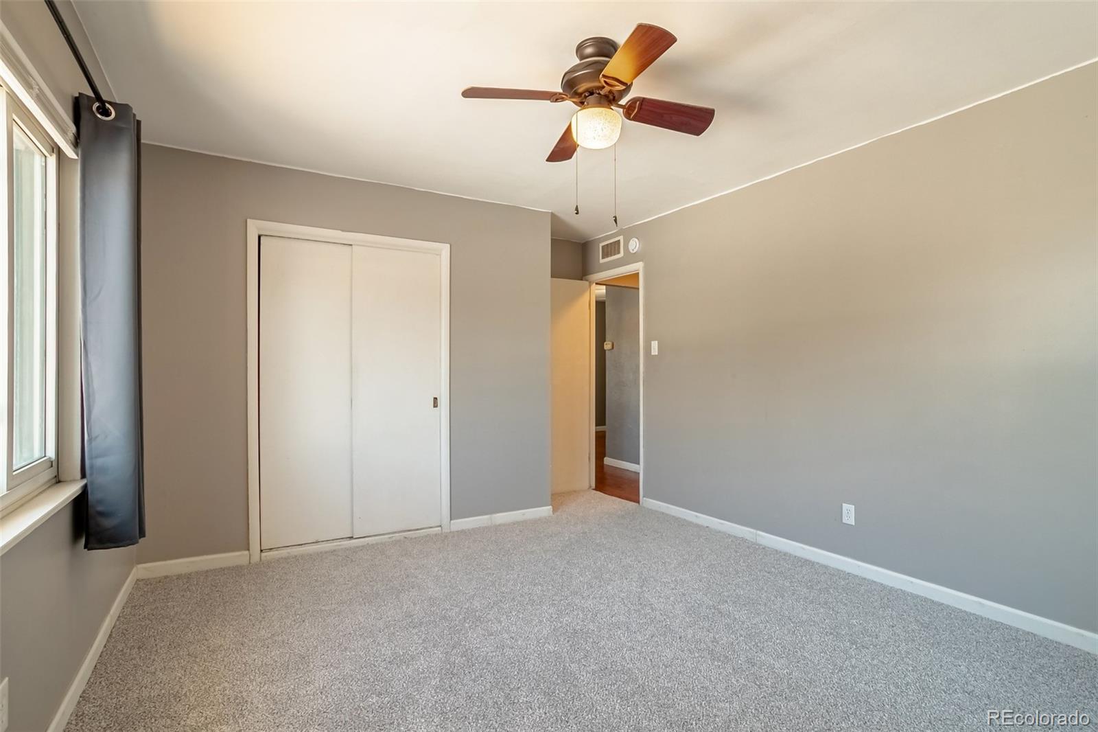 3016 South Grape Way Denver, CO 80222 - Photo 18 of 27 a view of room with a ceiling fan
