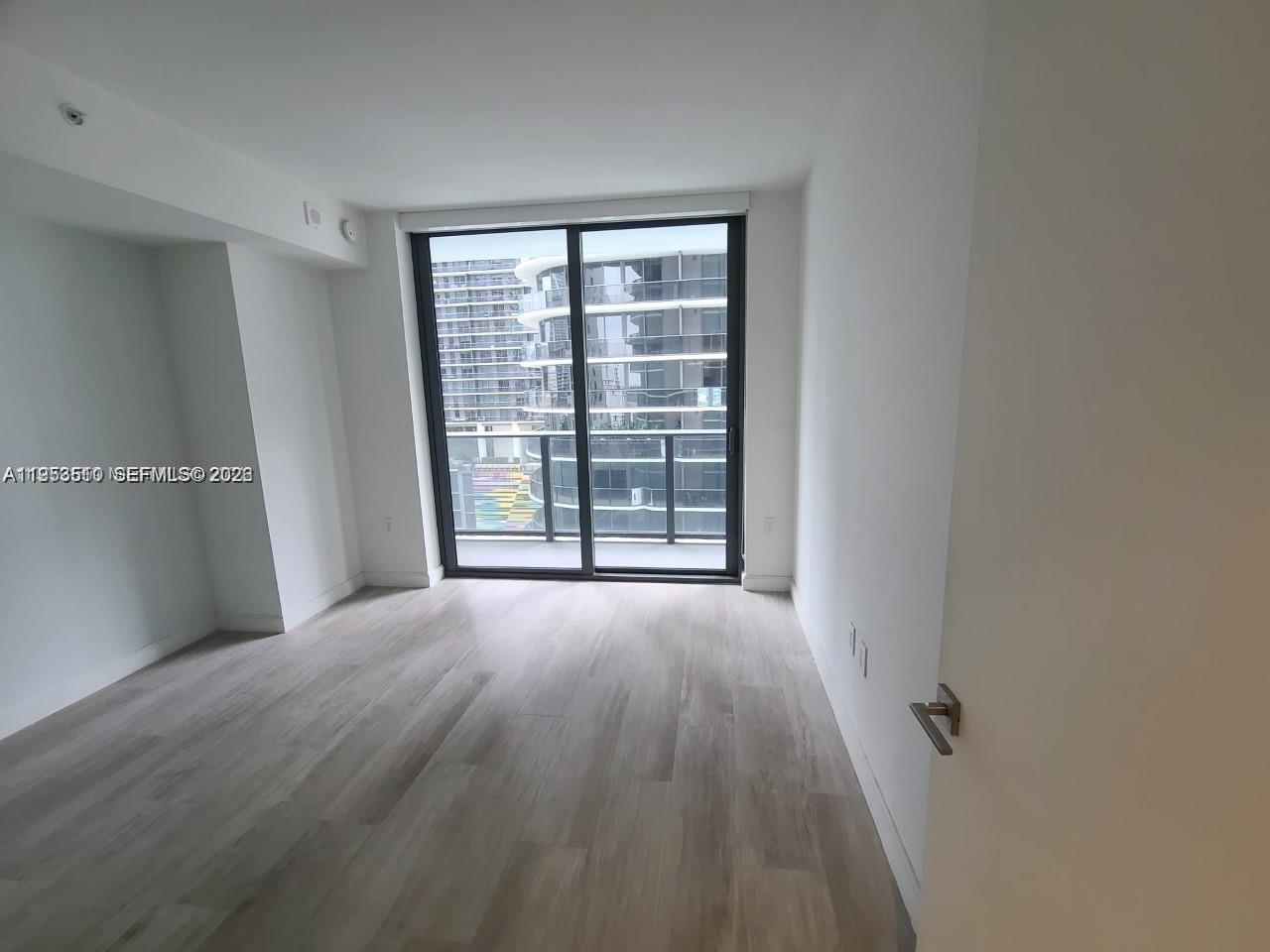 55 Southwest 9th Street, Unit 1502 Miami, FL 33130 - Photo 3 of 6 a view of an empty room with a window