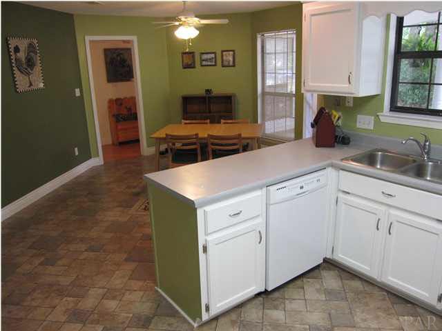 5085 Roland Road Pace, FL 32571 - Photo 9 of 24 View of kitchen looking towards foyer. Two pantries to your left.