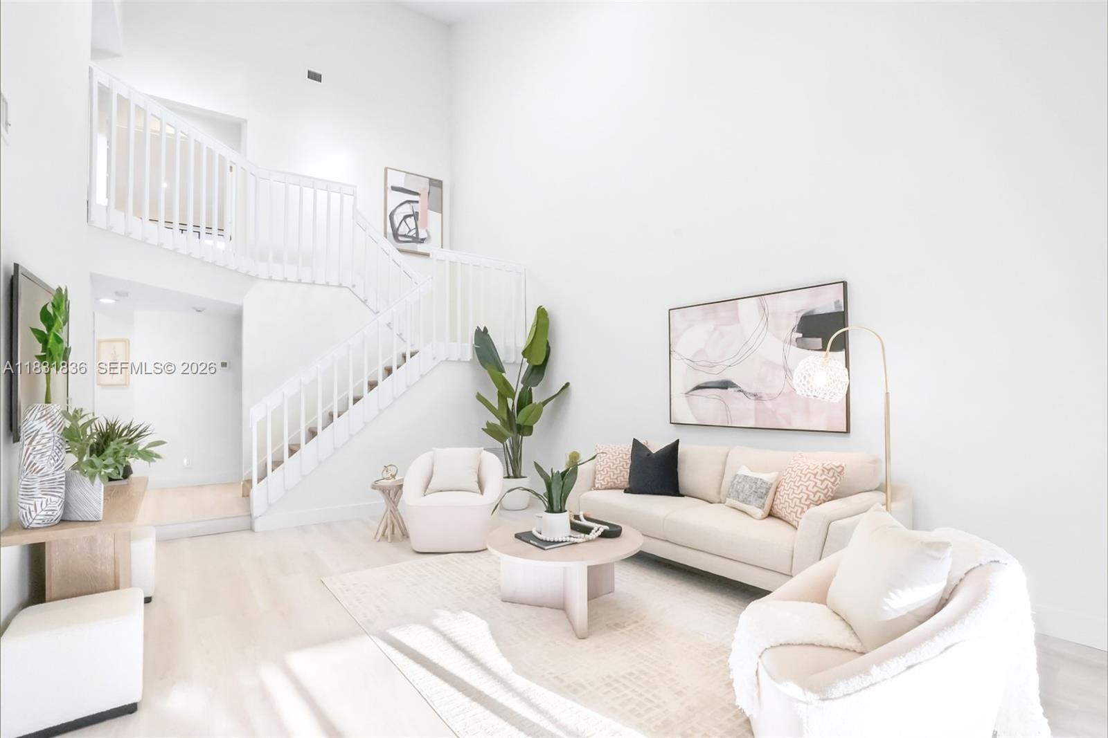 a living room with furniture and flowers