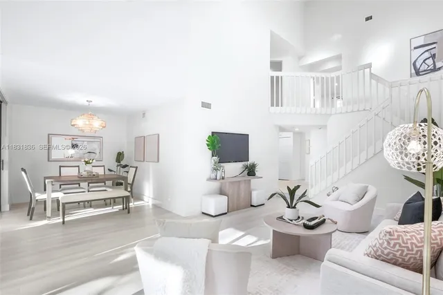 a living room with furniture and a dining table with wooden floor