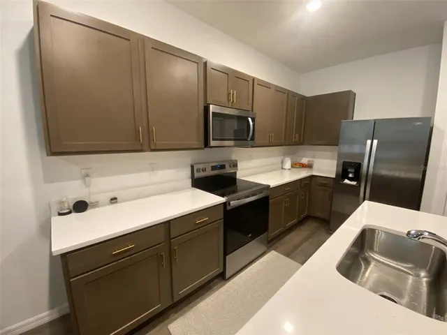 a kitchen with a refrigerator and a sink