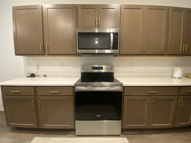 a view of a room with furniture and flowers