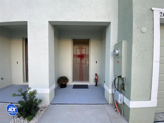 a hallway with beautiful frames and flower vase