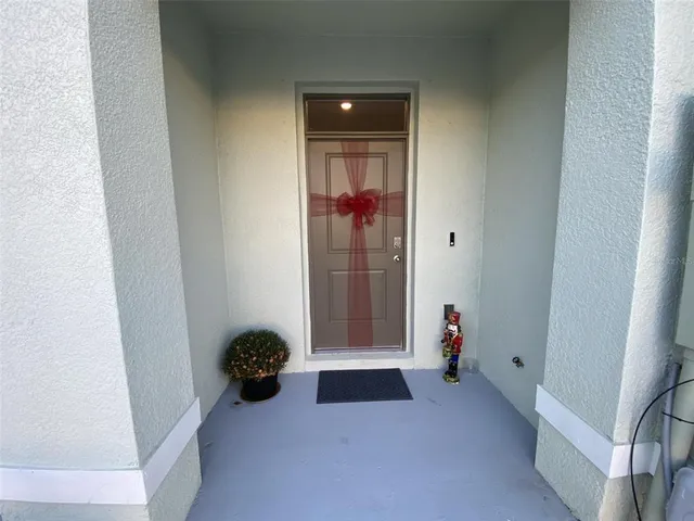 a view of a small space with wooden floor and a window