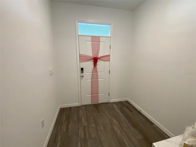 a view of a room with wooden floor and white walls
