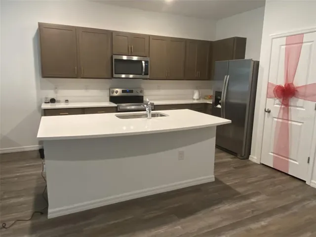 a kitchen with a sink stove and refrigerator
