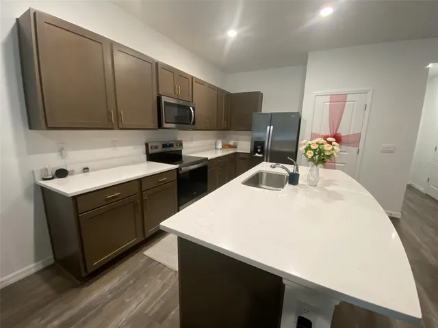 a kitchen with stainless steel appliances granite countertop a stove and a microwave