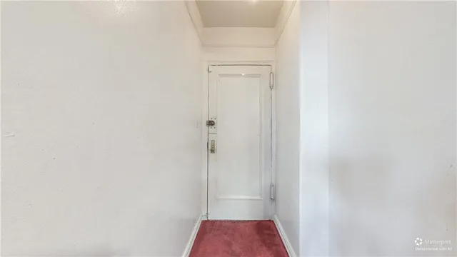 a view of a room with a ceiling fan and a bathroom