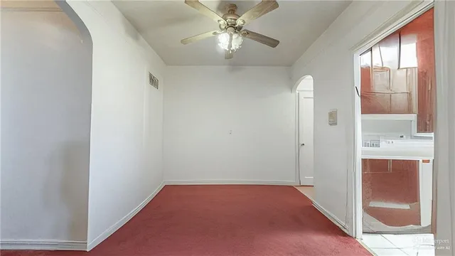 a view of a hallway with a chandelier fan
