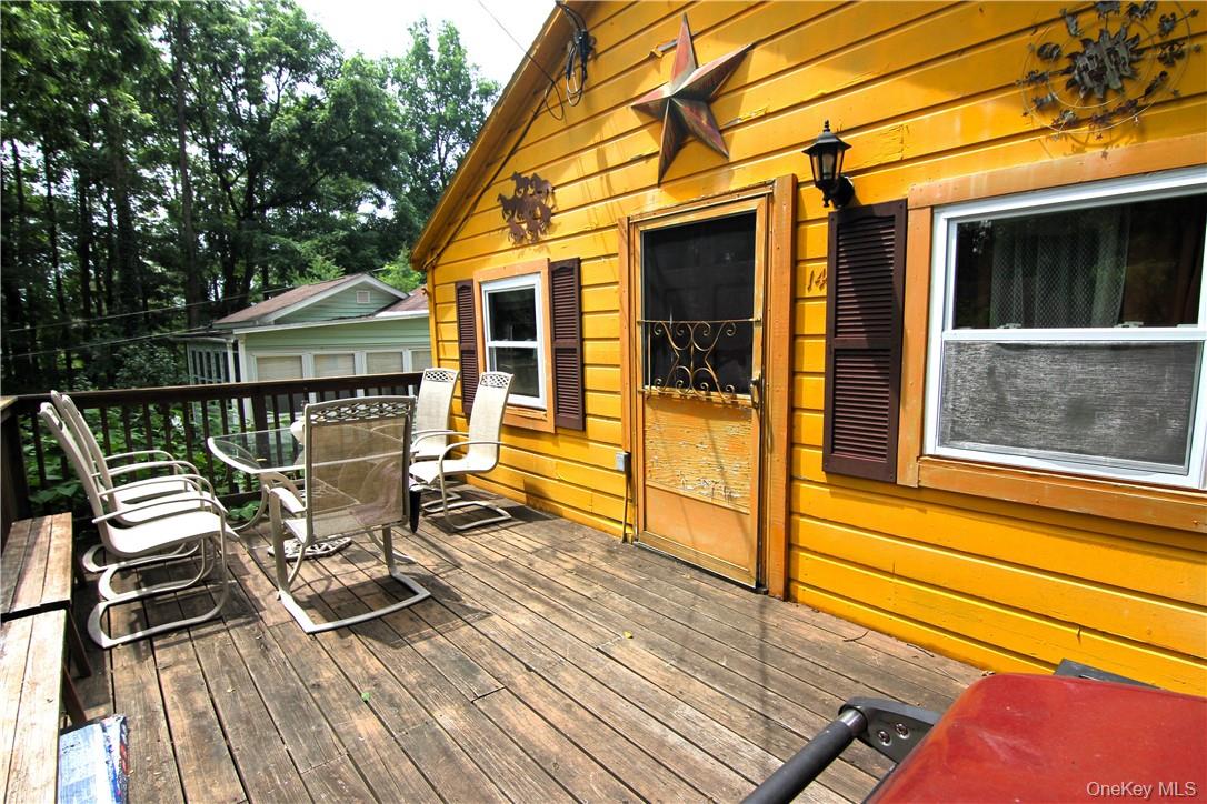 71 Miller Road, Unit 14 Hopewell Junction, NY 12533 - Photo 5 of 21 a view of a patio with table and chairs with wooden floor and fence