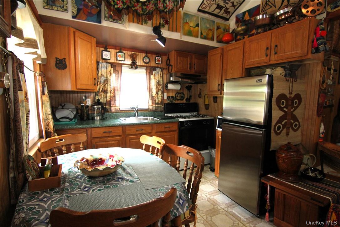 71 Miller Road, Unit 14 Hopewell Junction, NY 12533 - Photo 7 of 21 a kitchen with stainless steel appliances kitchen island granite countertop a sink a stove and a refrigerator