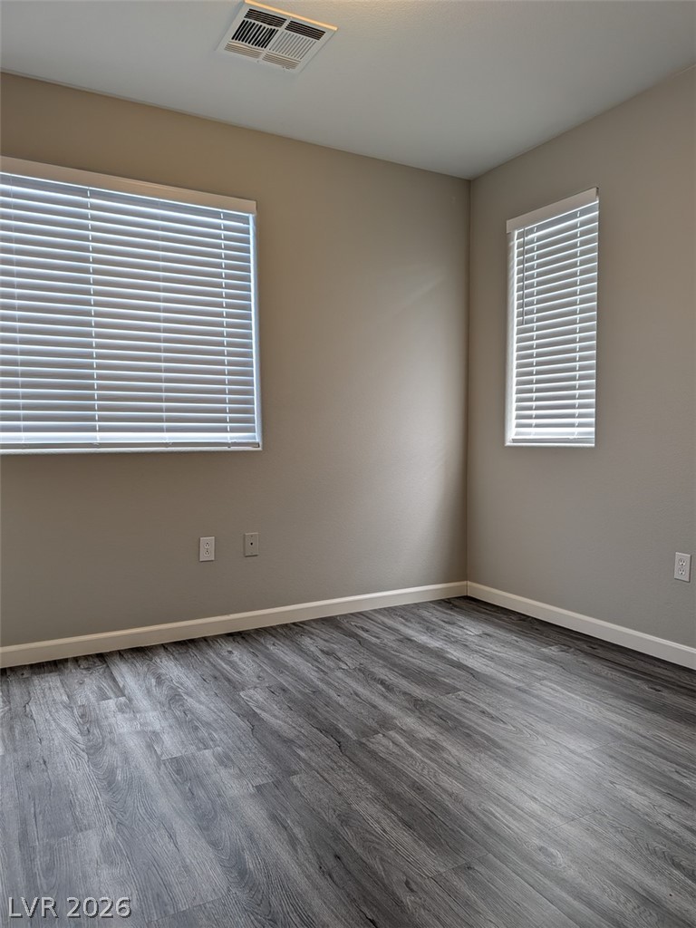 10308 Faustine Avenue Las Vegas, NV 89129 - Photo 23 of 28 Laminate flooring and two windows create a simple, yet comfortable, atmosphere for this room.