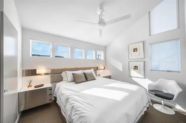 a bedroom with a bed and a mirror