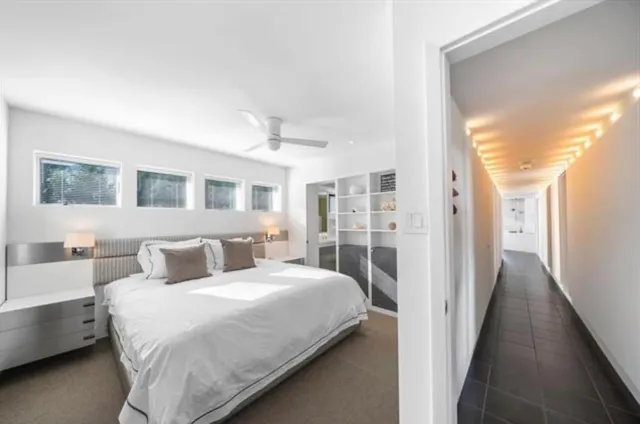 a spacious bedroom with a large bed and a window