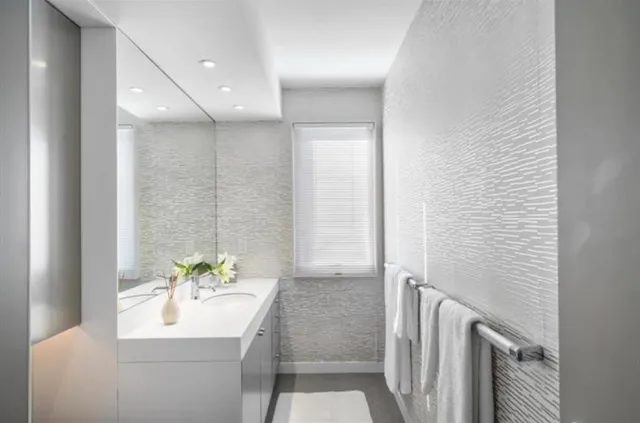 a bathroom with a granite countertop sink a toilet and a mirror