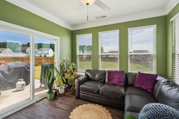 a dining room with furniture window and wooden floor