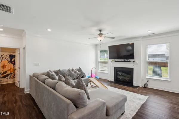 a living room with furniture a fireplace and a flat screen tv