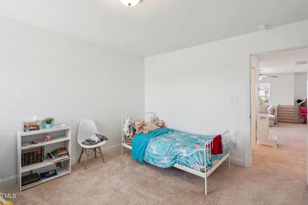 a bedroom with furniture and a baby crib