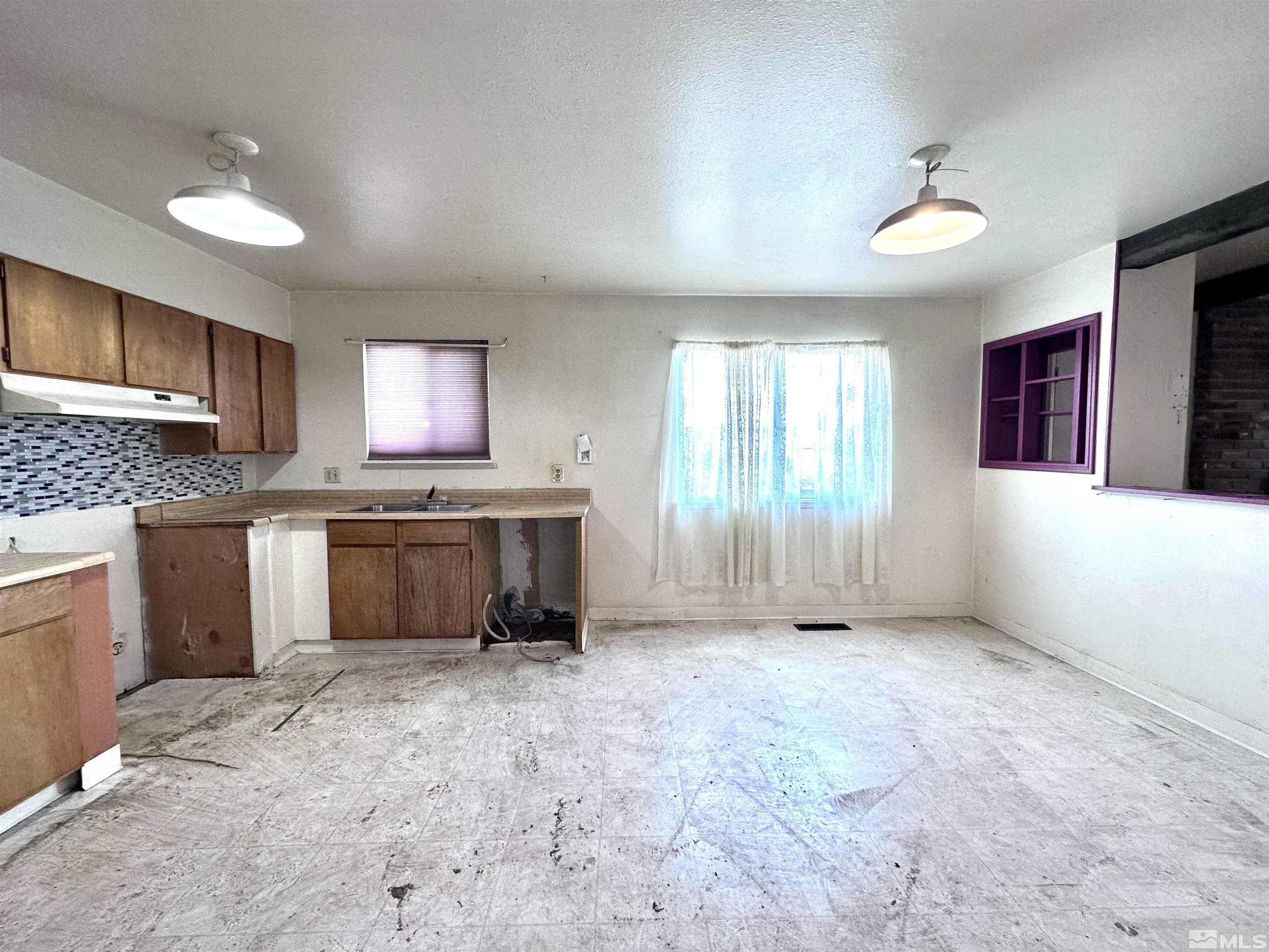 1202 Wilkinson Reno, NV 89503 - Photo 6 of 31 a large kitchen with a stove top oven a sink and dishwasher