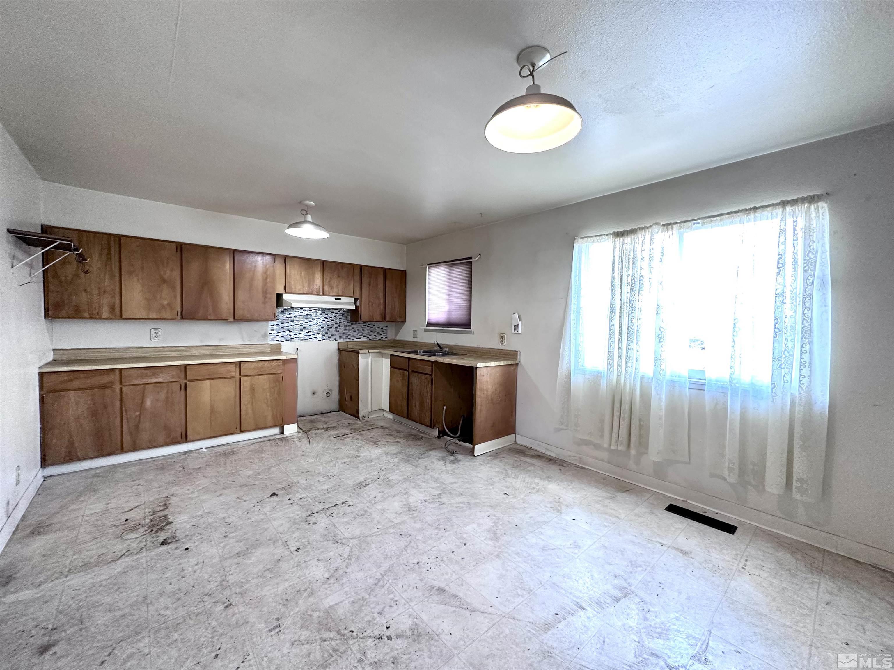 1202 Wilkinson Reno, NV 89503 - Photo 7 of 31 a kitchen with stainless steel appliances granite countertop a stove top oven a sink dishwasher and a refrigerator